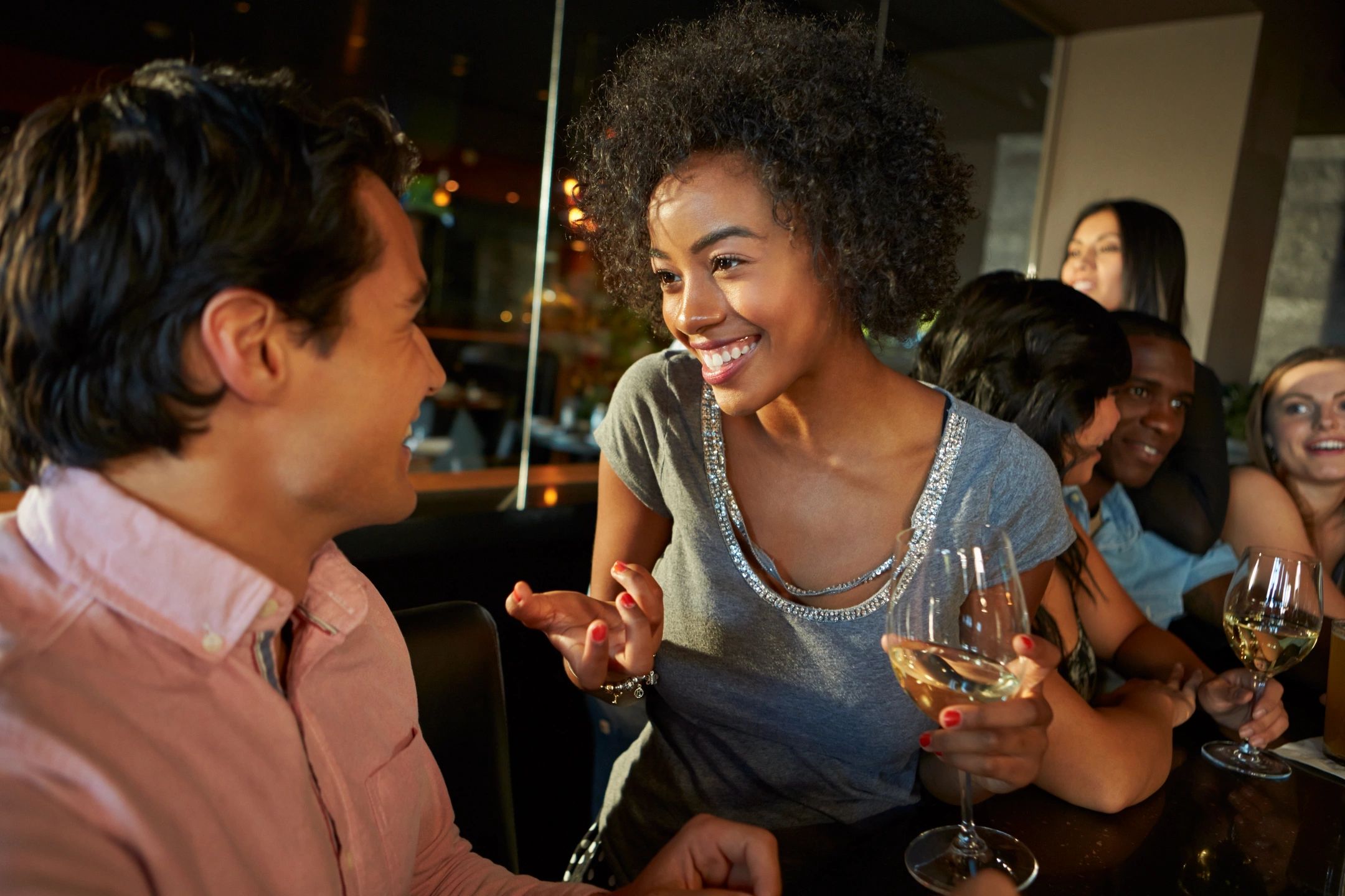 Two friends talking at a small gathering
